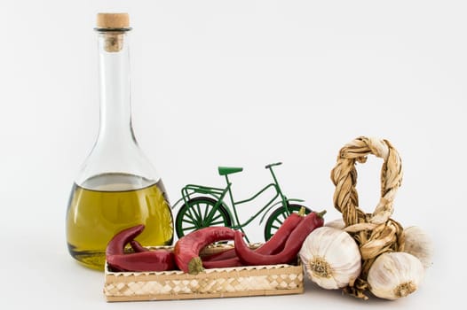 garlic, olive oil, and red pepper in the basket on white background