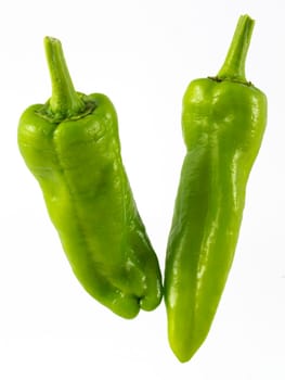 two green pepppers on white background