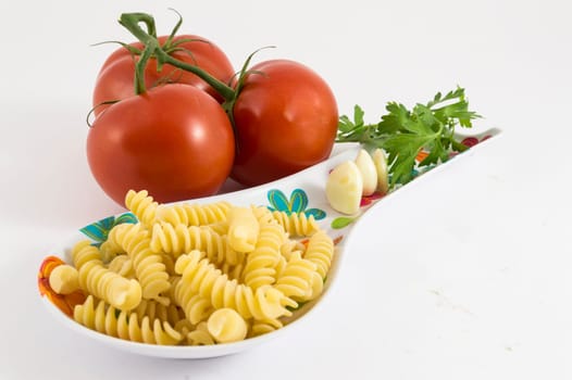 garlic, tomato, parsley and pasta on white background