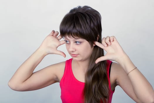 young girl stopped up their ears with his fingers