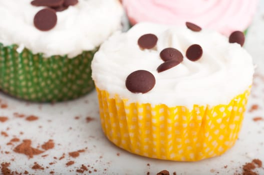 Three delicious cupcakes on a white plate