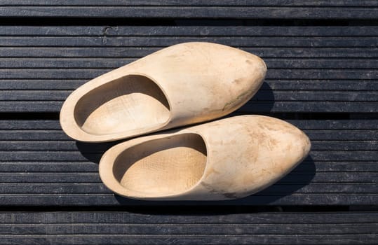 traditional handmade wooden shoes on dark wooden boards