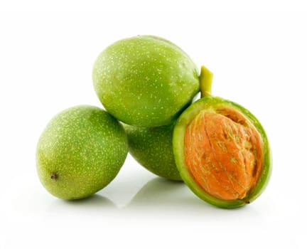 Ripe Broken Walnuts with Green Leaves Isolated on White Background