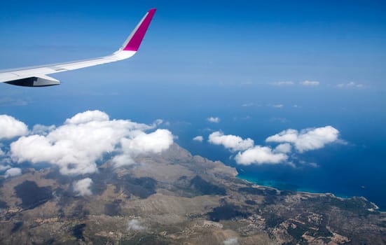 Plane wing and clouds viewed from airplane