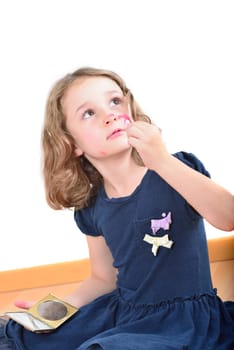Little cute girl using make-up to turn herself into clown