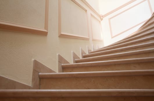Stylish stairwell with marble steps and stucco decorations