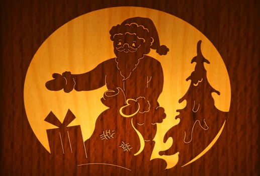 The close-up of a wood papercut with the motif of Santa Claus.