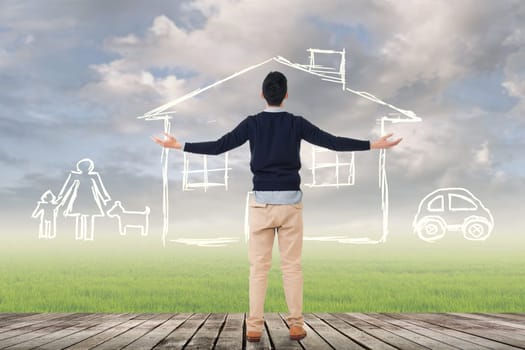 Asian man against the drawing house and family over grassland.