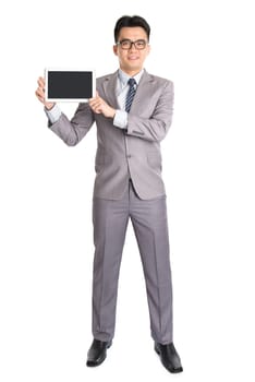 Full body Asian businessman hand holding digital computer tablet, standing isolated on white background.