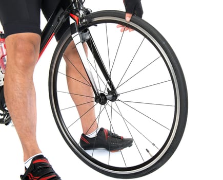 Cyclist checking on bike tyre air pressure, hand pressing the tire, isolated on white background.