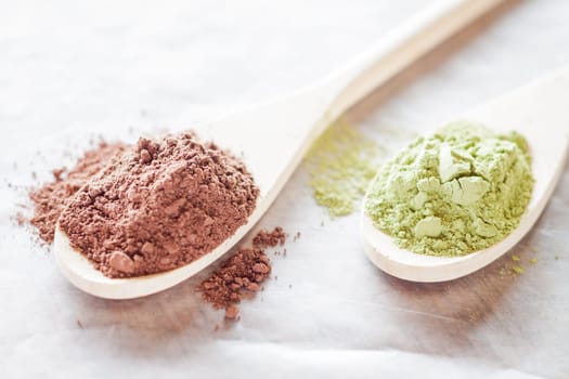 Spoon of cocoa and green tea powder, stock photo