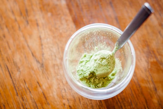 Green tea powder in glass, stock photo