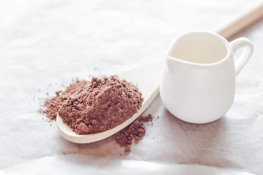 Powdered cocoa ingredient and fresh milk, stock photo
