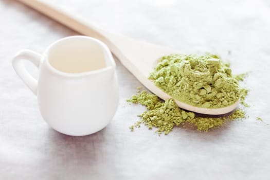 Powdered green tea ingredient and fresh milk, stock photo