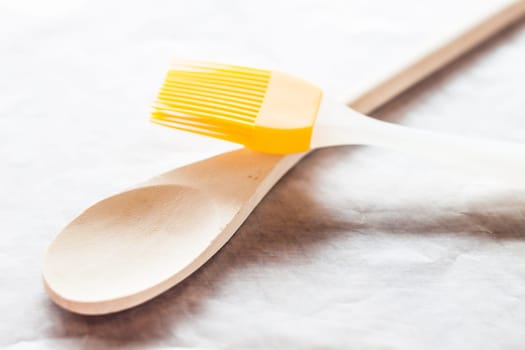 Spoon and brush on baking paper, stock photo