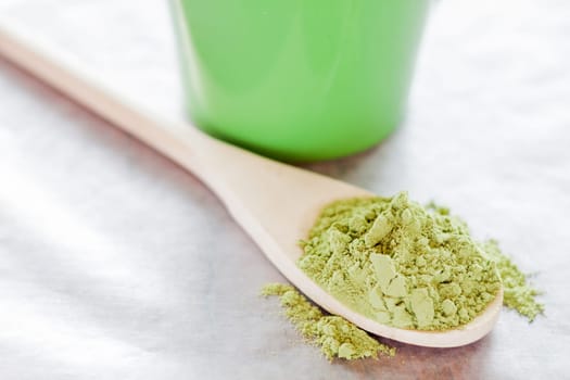 Powdered green tea with wooden spoon, stock photo