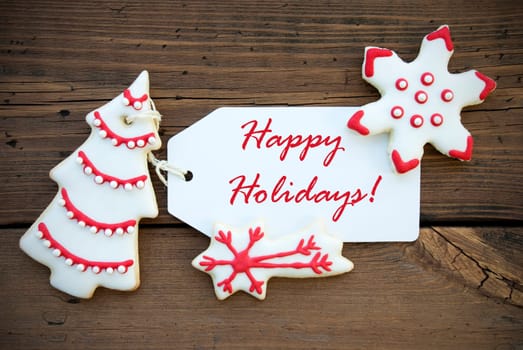 Red and White Decorated Winter Cookies with white Label and red Fond with Happy Holidays as Winter or Christmas Greetings
