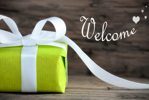 Green Gift with White Ribbon and the Word Welcome