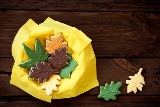 Autumnal Leaf Cookies in a Yellow Bowl on Wood with Copy Space for Your Text