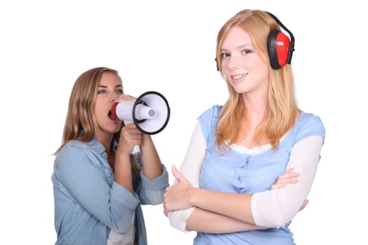 girl shouting in loudspeaker at female workmate