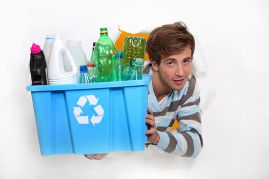 Man holding crate of bottles to be recycled