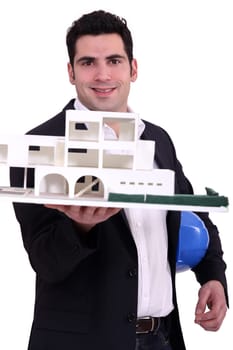 Architect holding up a building model