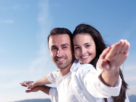 happy young romantic couple in love have fun on beautiful beach at beautiful summer day