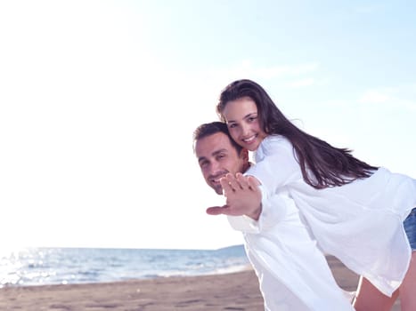 happy young romantic couple in love have fun on beautiful beach at beautiful summer day