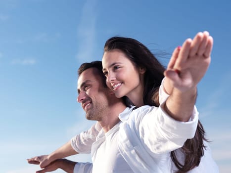 happy young romantic couple in love have fun on beautiful beach at beautiful summer day