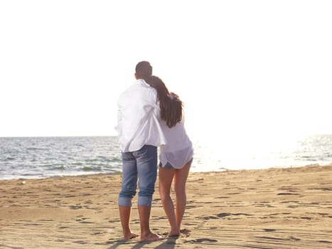 happy young romantic couple in love have fun on beautiful beach at beautiful summer day