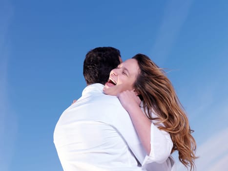 happy young romantic couple in love have fun on beautiful beach at beautiful summer day
