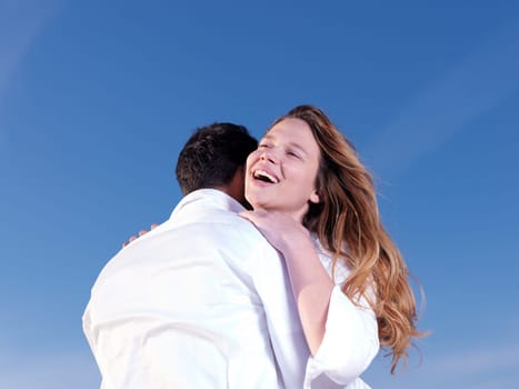 happy young romantic couple in love have fun on beautiful beach at beautiful summer day