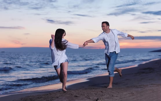 happy young romantic couple in love have fun on beautiful beach at beautiful summer day