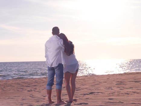 happy young romantic couple in love have fun on beautiful beach at beautiful summer day