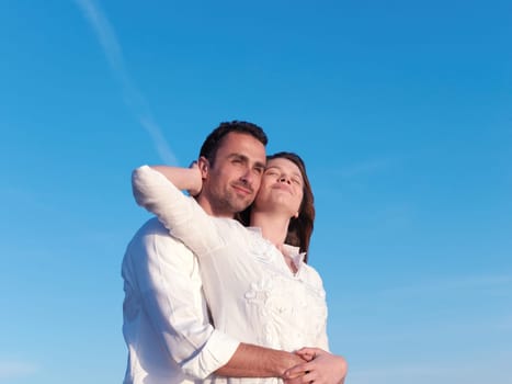 happy young romantic couple in love have fun on beautiful beach at beautiful summer day