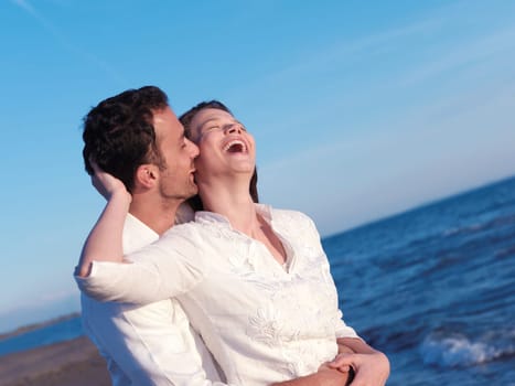 happy young romantic couple in love have fun on beautiful beach at beautiful summer day