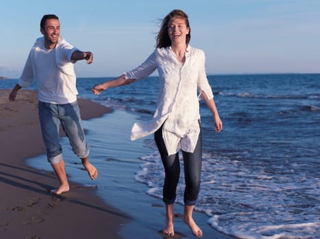 happy young romantic couple in love have fun on beautiful beach at beautiful summer day