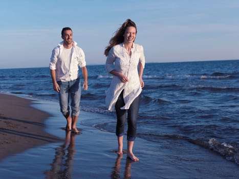 happy young romantic couple in love have fun on beautiful beach at beautiful summer day