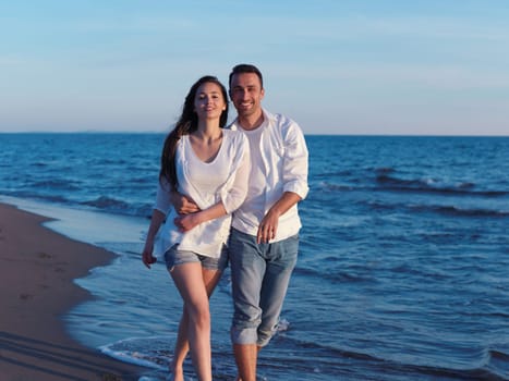 happy young romantic couple in love have fun on beautiful beach at beautiful summer day