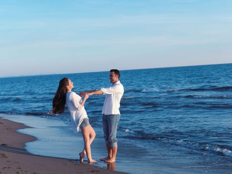 happy young romantic couple in love have fun on beautiful beach at beautiful summer day