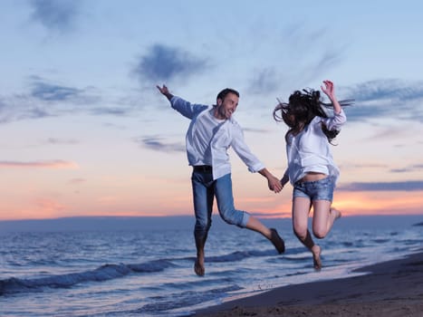 happy young romantic couple in love have fun on beautiful beach at beautiful summer day