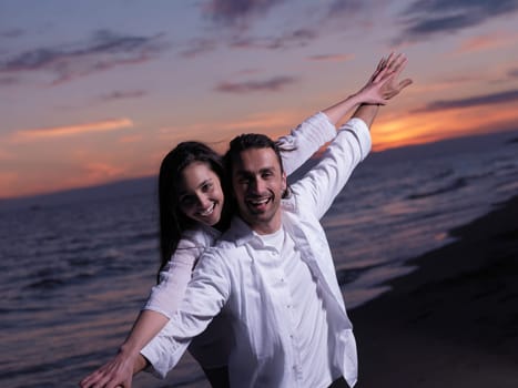 happy young romantic couple in love have fun on beautiful beach at beautiful summer day