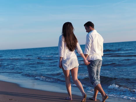 happy young romantic couple in love have fun on beautiful beach at beautiful summer day