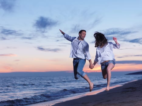 happy young romantic couple in love have fun on beautiful beach at beautiful summer day