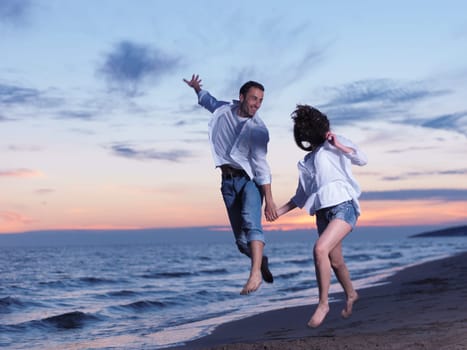 happy young romantic couple in love have fun on beautiful beach at beautiful summer day