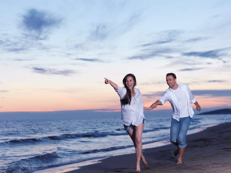 happy young romantic couple in love have fun on beautiful beach at beautiful summer day