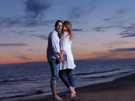 happy young romantic couple in love have fun on beautiful beach at beautiful summer day