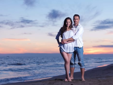 happy young romantic couple in love have fun on beautiful beach at beautiful summer day