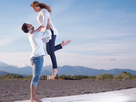 happy young romantic couple in love have fun on beautiful beach at beautiful summer day