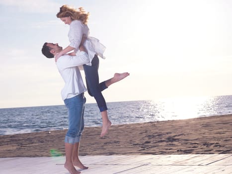 happy young romantic couple in love have fun on beautiful beach at beautiful summer day